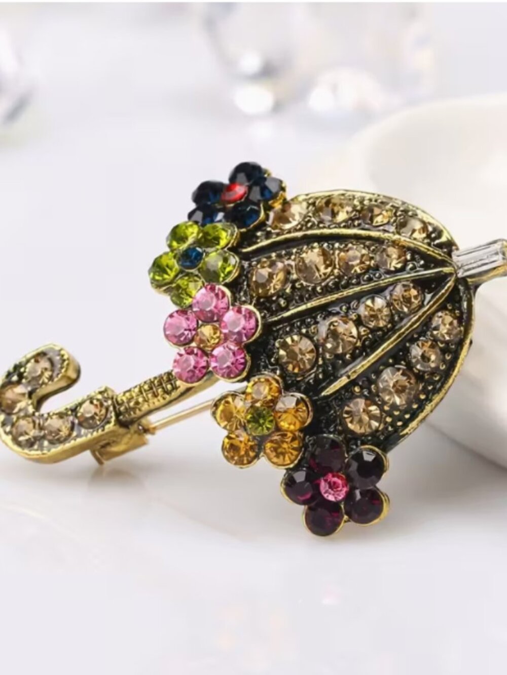 Sparkling gold-tone brooch with colorful stones. NWT